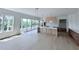 Open-concept kitchen with island, modern lighting, and access to outdoor space through sliding glass doors at 5753 Brendlynn Dr, Suwanee, GA 30024
