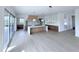 Expansive kitchen boasts an island, custom cabinets, and sliding doors leading to the outdoor deck at 5753 Brendlynn Dr, Suwanee, GA 30024