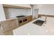 Well-lit kitchen featuring marble countertops, stainless steel appliances, and light wood cabinetry at 5753 Brendlynn Dr, Suwanee, GA 30024