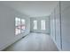 Bright living room featuring natural light, hardwood floors, and custom wall trim at 5753 Brendlynn Dr, Suwanee, GA 30024