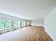 Open living room with hardwood floors and access to the deck at 5753 Brendlynn Dr, Suwanee, GA 30024