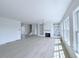 Open-concept living room with fireplace, built-ins, and abundant natural light from the many windows at 5753 Brendlynn Dr, Suwanee, GA 30024
