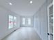 Bright living room with decorative paneled wall and light hardwood flooring at 5753 Brendlynn Dr, Suwanee, GA 30024
