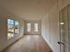 Bright living room with hardwood floors, stylish wall paneling, and large windows at 5753 Brendlynn Dr, Suwanee, GA 30024