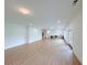 Spacious living area with hardwood floors, natural light, and a built-in bar at 5753 Brendlynn Dr, Suwanee, GA 30024