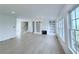 Bright, airy living room boasts built-in shelving, a fireplace, and ample natural light from large windows at 5753 Brendlynn Dr, Suwanee, GA 30024