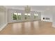 Bright living room featuring hardwood floors, a modern fireplace, and three large windows offering scenic views at 5753 Brendlynn Dr, Suwanee, GA 30024