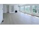 Spacious living room with large windows, fireplace, and built-in shelving provides ample natural light at 5753 Brendlynn Dr, Suwanee, GA 30024