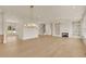 Spacious living room featuring hardwood floors, a fireplace, and modern lighting fixtures at 5753 Brendlynn Dr, Suwanee, GA 30024
