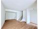 Spacious open-plan living room with hardwood floors and staircase at 5753 Brendlynn Dr, Suwanee, GA 30024