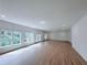 Bright, open living room featuring hardwood floors, recessed lighting, and large windows with natural light at 5753 Brendlynn Dr, Suwanee, GA 30024