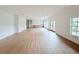 Living room with hardwood floors, wet bar, and a door to the deck at 5753 Brendlynn Dr, Suwanee, GA 30024