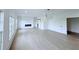 Expansive living area featuring modern fireplace, barn door and high ceilings, with ample natural light at 5753 Brendlynn Dr, Suwanee, GA 30024