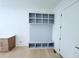 Neat mudroom with a practical bench, hanging hooks, storage cubbies, and a convenient side entrance at 5753 Brendlynn Dr, Suwanee, GA 30024