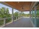Spacious porch with wooden floors, a wooden ceiling, and a serene wooded view at 5753 Brendlynn Dr, Suwanee, GA 30024