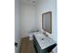 Stylish powder room features a modern vanity with a marble countertop and decorative mirror at 5753 Brendlynn Dr, Suwanee, GA 30024