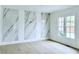 Bright room featuring an accent wall and hardwood flooring at 5753 Brendlynn Dr, Suwanee, GA 30024