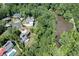 Aerial view of the home's location, surrounded by lush greenery and a peaceful lake at 225 Blueberry Rdg, Milton, GA 30075