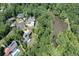 Aerial view of community homes near a lush green forest and pond at 225 Blueberry Rdg, Milton, GA 30075