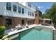 Expansive backyard with a luxurious pool, patio, and lush landscaping at 225 Blueberry Rdg, Milton, GA 30075