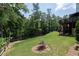 Lush backyard featuring a large tree and a glimpse of the deck creating a private, natural setting at 225 Blueberry Rdg, Milton, GA 30075