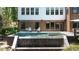Gorgeous backyard showcases an in-ground pool with a soothing water feature at 225 Blueberry Rdg, Milton, GA 30075