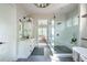 Bright bathroom with a glass-enclosed shower, a double vanity with sleek fixtures, and access to a bedroom at 225 Blueberry Rdg, Milton, GA 30075