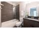 Beautiful bathroom boasts a tiled shower over tub and dark wood vanity at 225 Blueberry Rdg, Milton, GA 30075