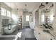 Bright bathroom features a modern soaking tub, glass shower, double vanity, and updated decorative lighting at 225 Blueberry Rdg, Milton, GA 30075