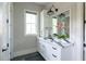 Modern bathroom with double vanity featuring stylish lighting and a decorative flower arrangement at 225 Blueberry Rdg, Milton, GA 30075