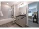 Neutral bathroom featuring shower over tub with a glass door, and gray vanity at 225 Blueberry Rdg, Milton, GA 30075