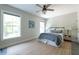 Cozy bedroom with two bright windows, ceiling fan, and neutral décor at 225 Blueberry Rdg, Milton, GA 30075