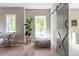 Bright bedroom with a decorative sliding barn door, inviting seating area, and views of the surrounding greenery at 225 Blueberry Rdg, Milton, GA 30075