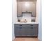 Stylish butler's pantry with gray cabinets, a white countertop, and a wine rack at 225 Blueberry Rdg, Milton, GA 30075