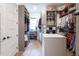 Well-organized walk-in closet with custom shelving, hanging racks, and an island for accessories, maximizing storage at 225 Blueberry Rdg, Milton, GA 30075