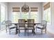 Elegant dining room featuring a wooden table, upholstered chairs, and plenty of natural light at 225 Blueberry Rdg, Milton, GA 30075