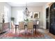 Sophisticated dining room featuring a modern chandelier, decorative mirrors, and a patterned rug at 225 Blueberry Rdg, Milton, GA 30075