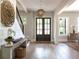 Stylish foyer with a decorative light fixture, staircase, and access to multiple rooms at 225 Blueberry Rdg, Milton, GA 30075