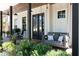 Inviting front porch with a swing, rocking chairs, and beautiful landscaping at 225 Blueberry Rdg, Milton, GA 30075
