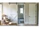 Hallway leading to a modern ensuite bathroom with sliding barn door, decorative lighting, and modern fixtures at 225 Blueberry Rdg, Milton, GA 30075