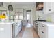 Well-appointed kitchen with custom cabinets, a modern farmhouse sink, and wood floors at 225 Blueberry Rdg, Milton, GA 30075