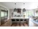 Modern kitchen featuring a large island, stainless steel appliances, and stylish light fixtures at 225 Blueberry Rdg, Milton, GA 30075