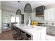 Elegant kitchen with a quartz island, farmhouse sink, and stainless steel appliances at 225 Blueberry Rdg, Milton, GA 30075