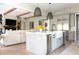 Bright, open kitchen boasts a center island with modern appliances and stylish pendant lighting at 225 Blueberry Rdg, Milton, GA 30075