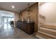 Hallway with a stylish wet bar featuring a wood accent wall and pendant lighting at 225 Blueberry Rdg, Milton, GA 30075