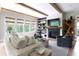 Cozy living room with a fireplace, exposed beams, and plush seating at 225 Blueberry Rdg, Milton, GA 30075