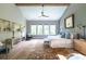Comfortable main bedroom with high ceilings, ceiling fan, a sitting area, and plenty of light from large windows at 225 Blueberry Rdg, Milton, GA 30075