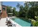 Stunning pool area with outdoor seating and a private wooded backdrop at 225 Blueberry Rdg, Milton, GA 30075
