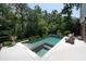 Scenic backyard features a sparkling pool, spa, and lush greenery at 225 Blueberry Rdg, Milton, GA 30075