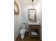 Rustic powder room with shiplap walls, a vanity, a mirror, and a toilet at 225 Blueberry Rdg, Milton, GA 30075